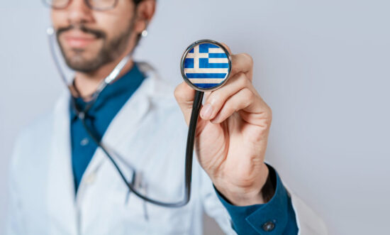 health care in greece, doctor with stethoscope with greek flag