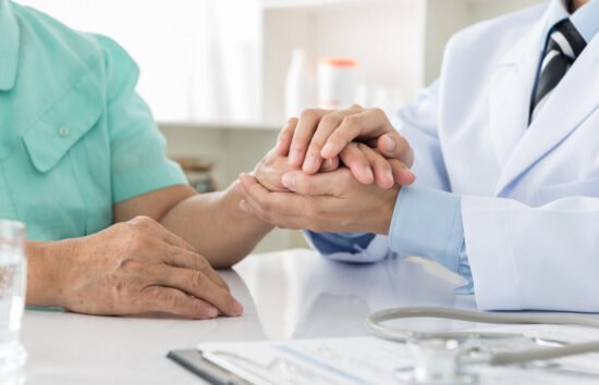 doctor holding hand of patient