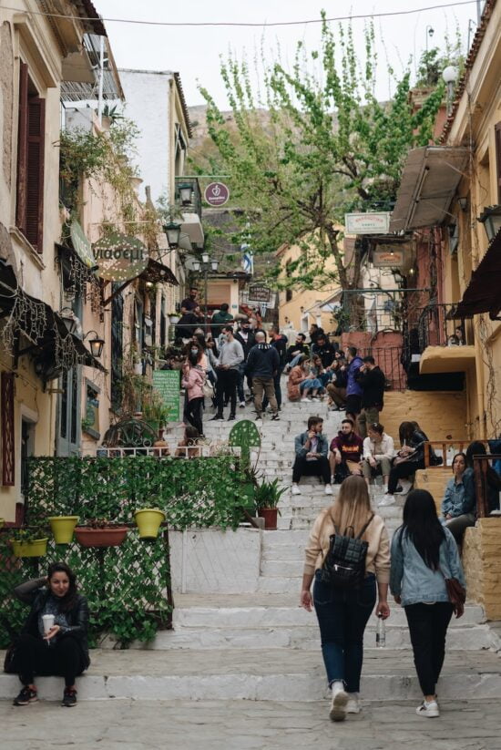 cost of living in athens, a group of people walking in athens