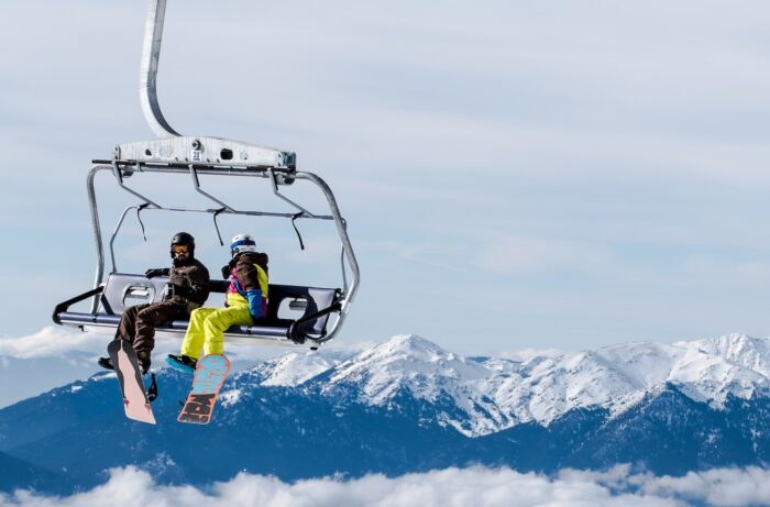 two person riding cable car enjoying skiing in greece